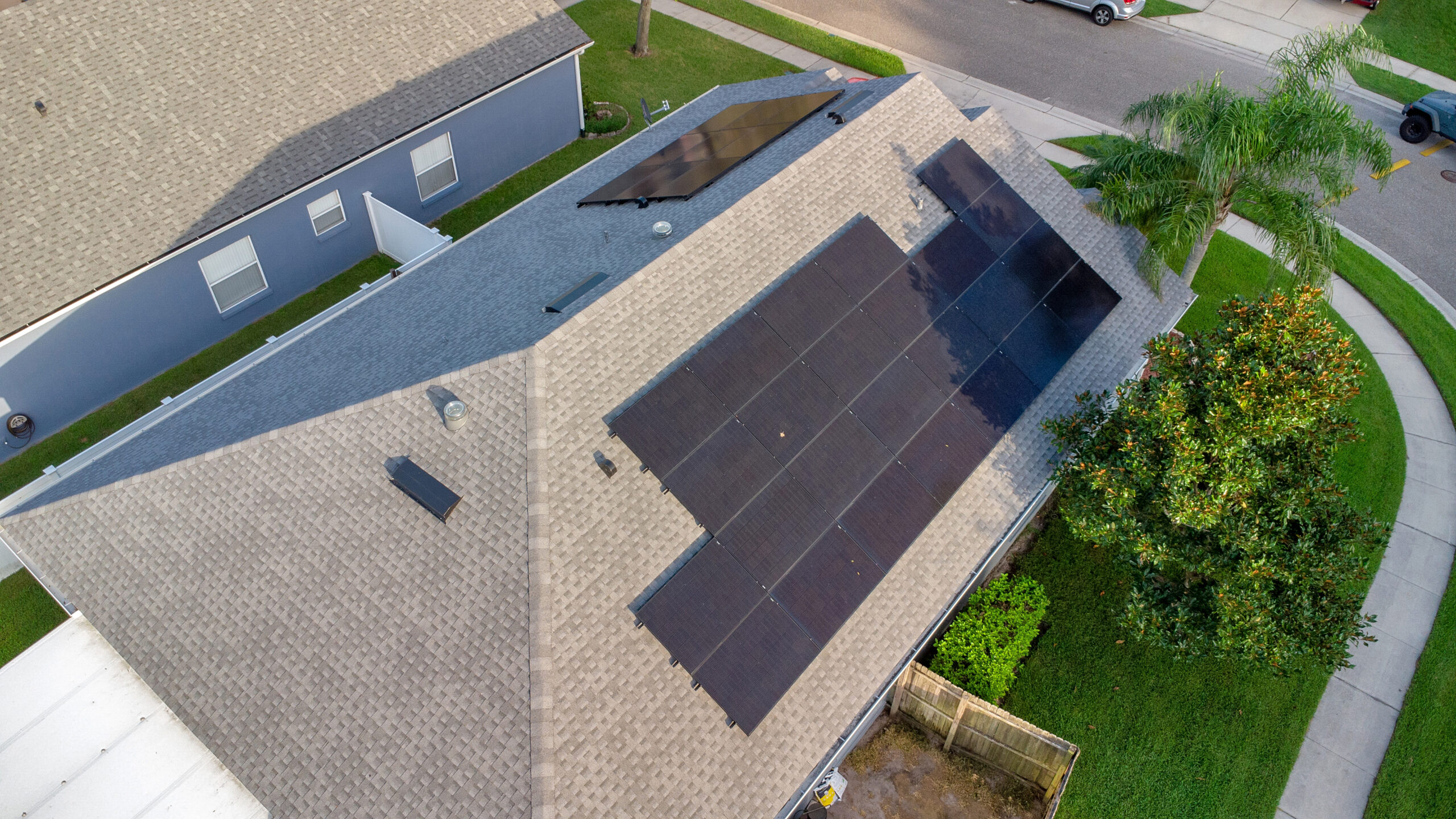 Black solar panels on the roof of a Lake Mary home
