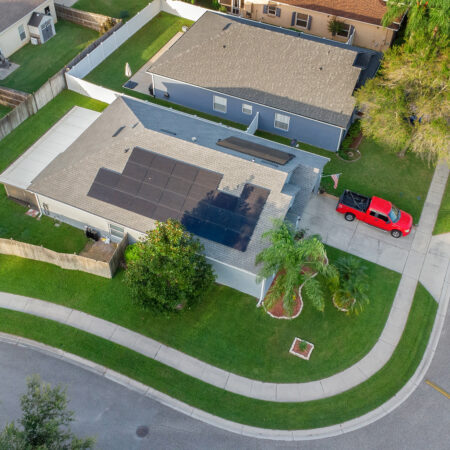 zoomed out, aerial view of black solar panels on a Lake Mary, Florida roof.