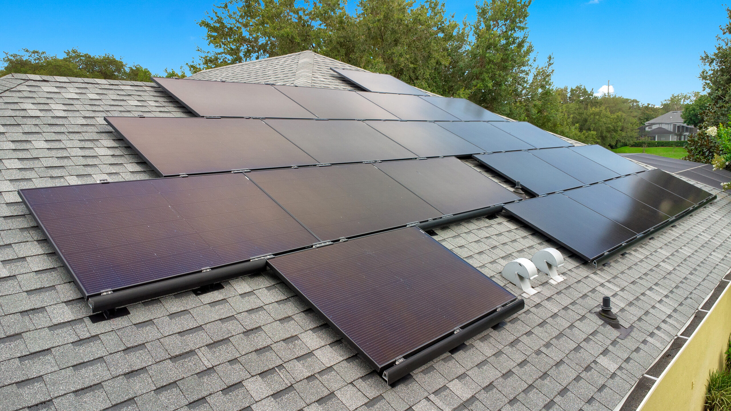 close up image of sleek black solar panels on a yellow home in deltona, florida
