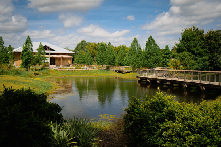 Lake surrounded by historic building and dock at Reiter community parkin Longwood, Florida