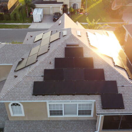 rays of sunshine bouncing off the solar panels on the roof of a residential home in Clermont, Florida